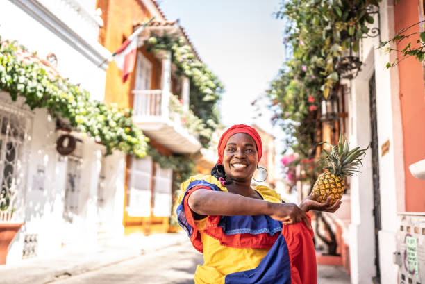 Palenquera walking on the street in Cartagena, Colombia Palenquera walking on the street in Cartagena, Colombia